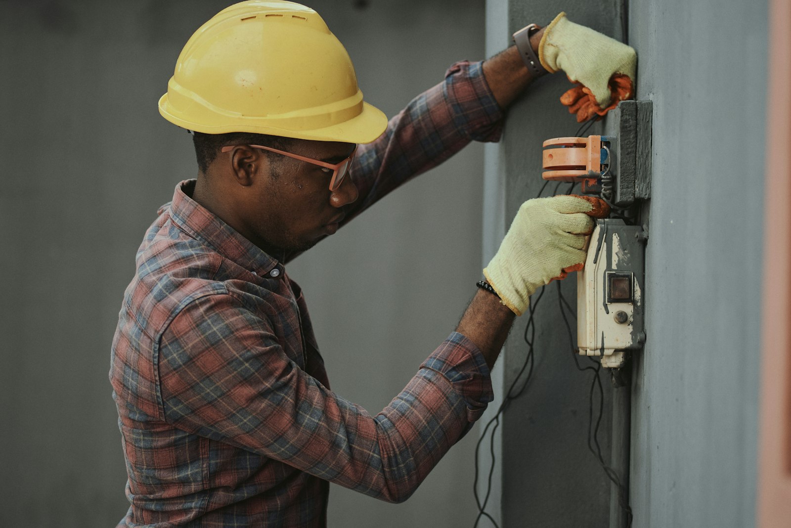 Engineer in a hard hat reviewing drawings on site.