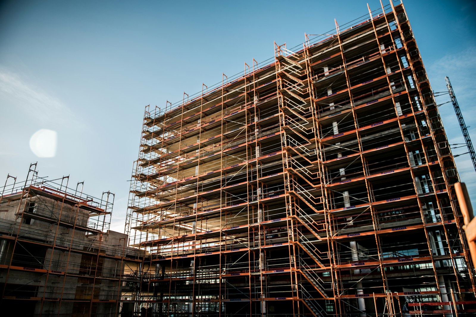 A multi-storey building under construction behind scaffolding.