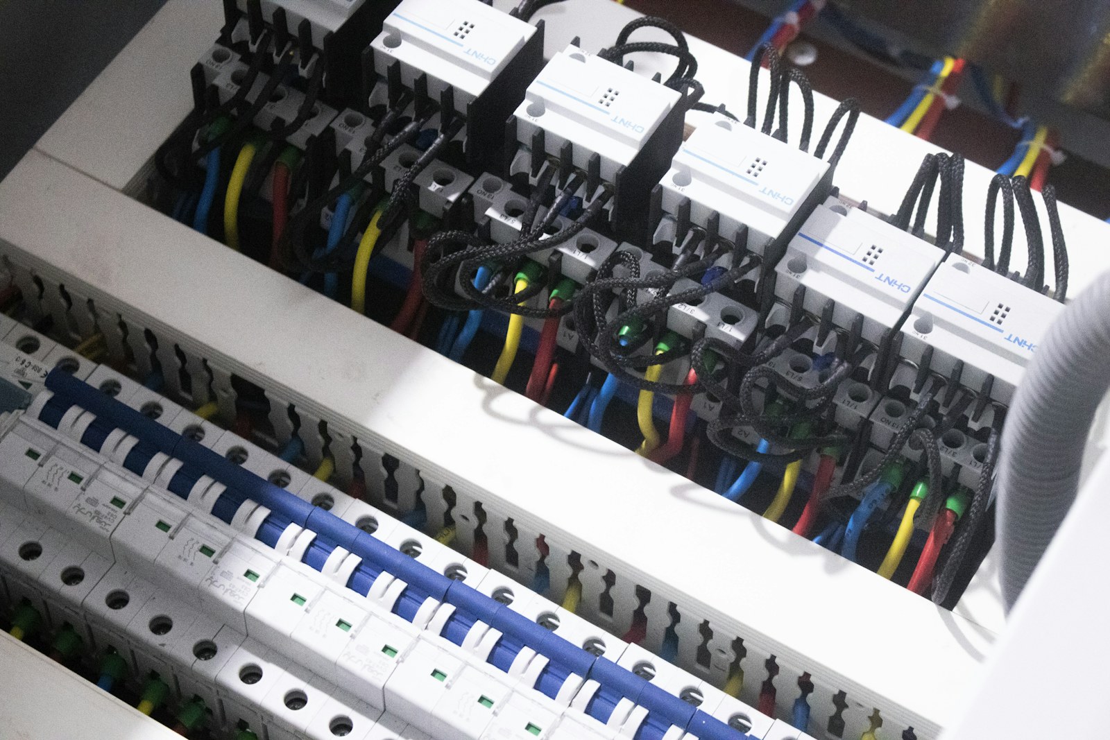 An electrical distribution board with breakers and wiring.