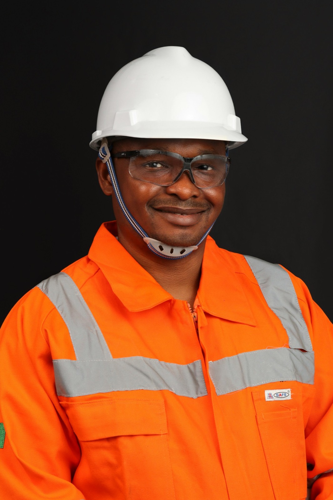 A BANEC site worker in a hard hat and high-visibility coverall.