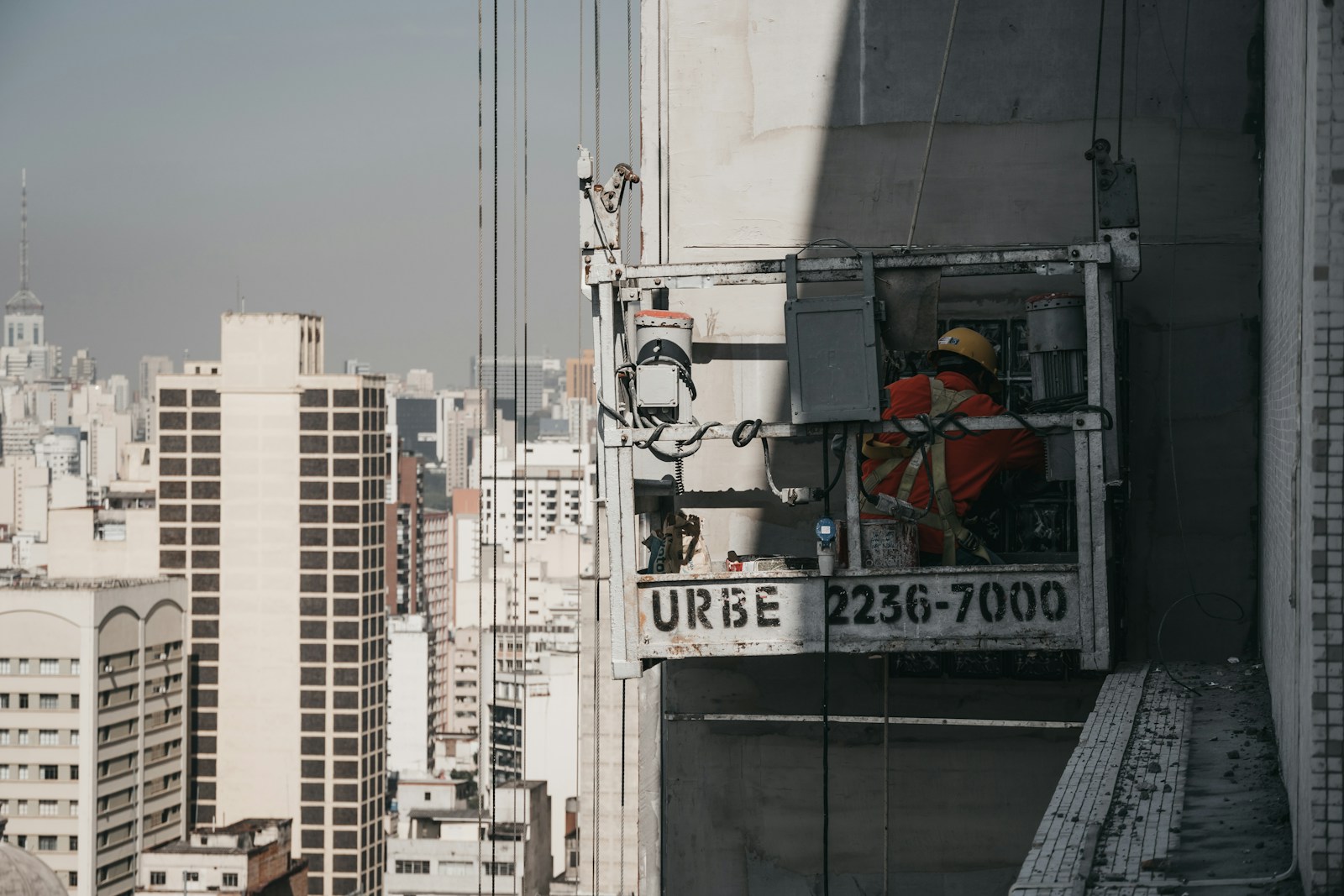 Mason at work on a reinforced-concrete frame.