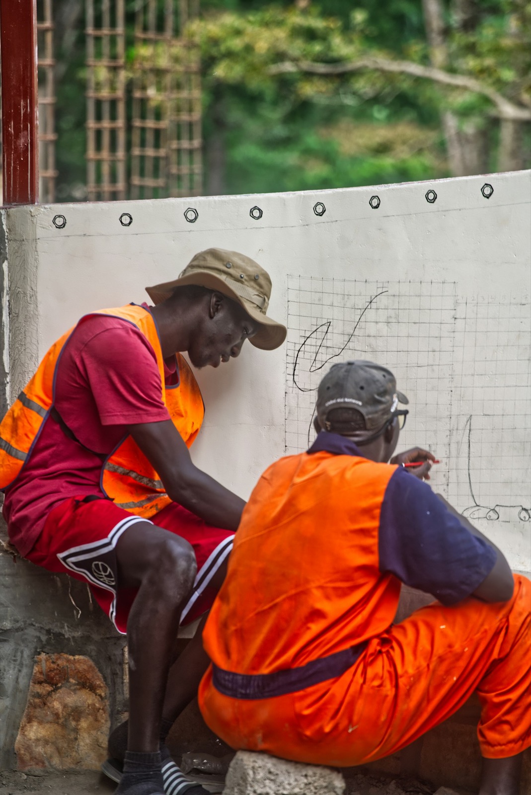 Engineers and a contractor reviewing construction drawings during a site visit.